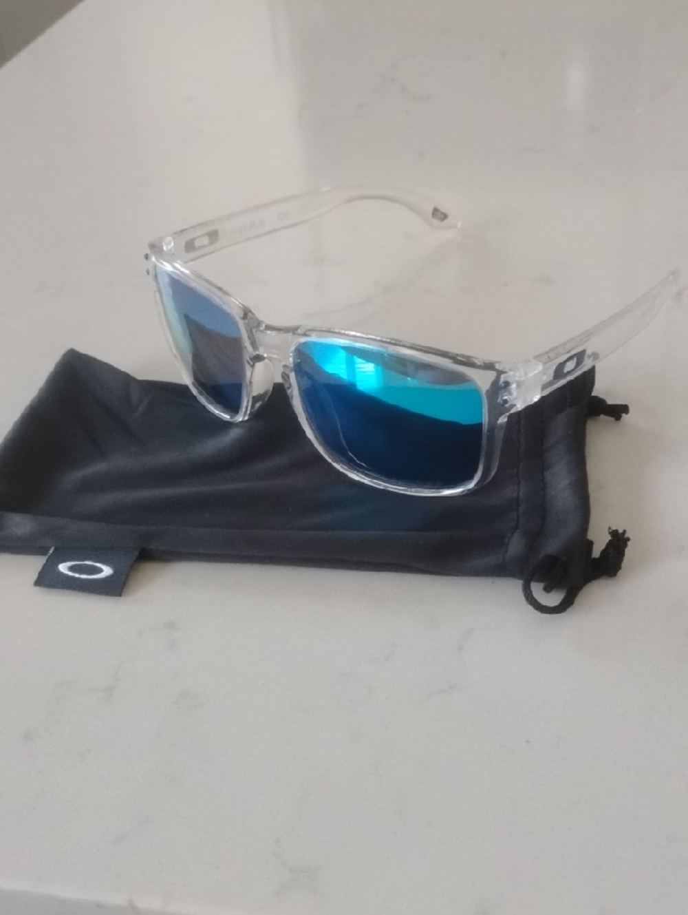 Oakley Clear Frame Sunglasses with Blue Mirrored Lenses